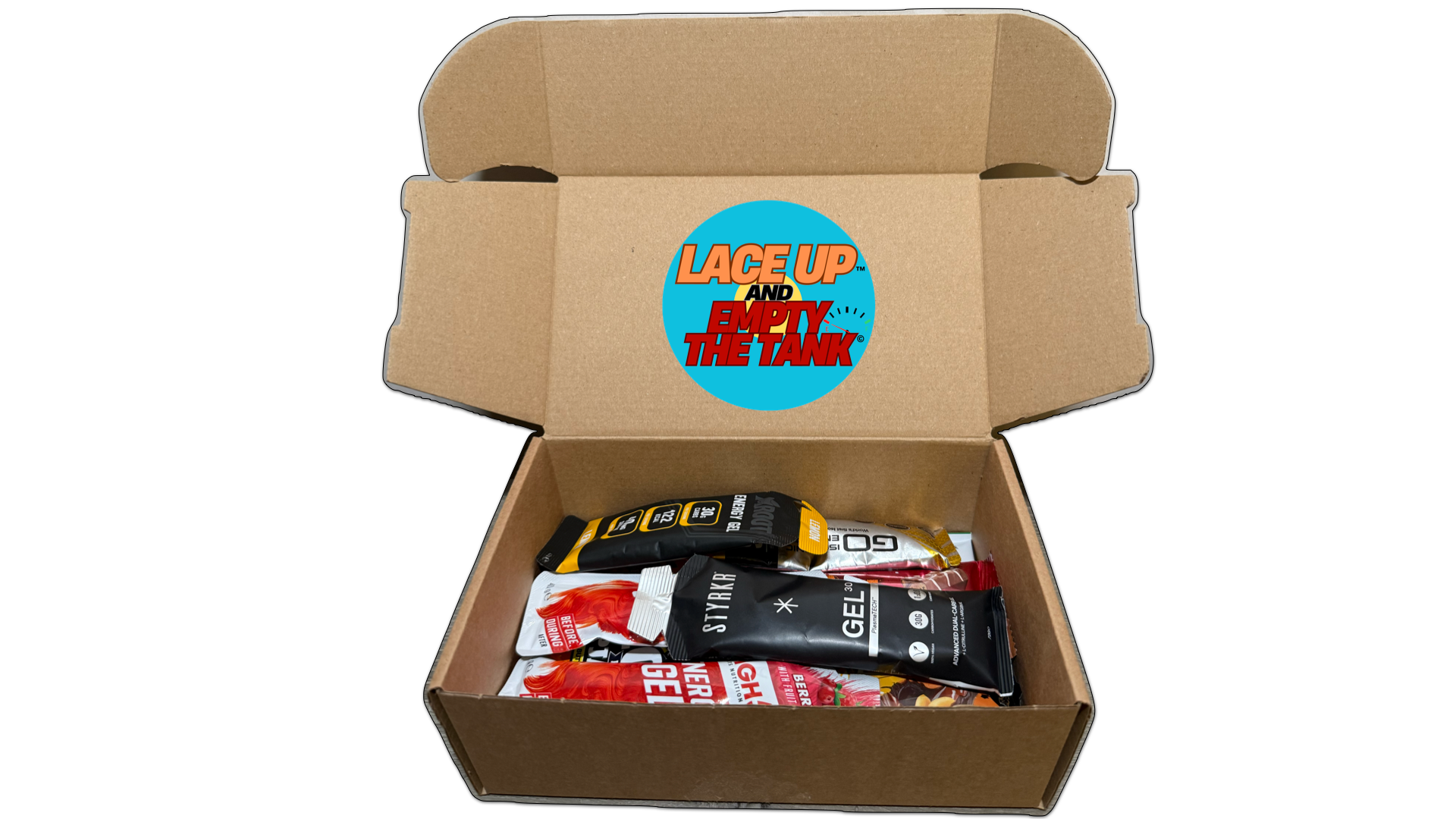 mix box with styrkr premium running gels, pillar recovery drinks, active roots electrolytes, grenade protein bars, creatine bars, caffeine gels and high energy drinks, all packaged away